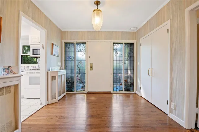 a view of an entryway with wooden floor