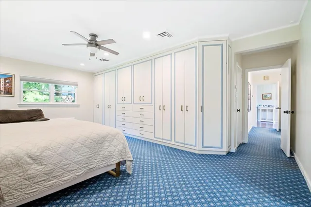 a spacious bedroom with a bed closet and a window