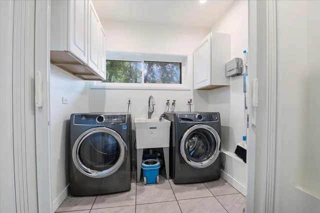 a utility room with sink dryer and washer