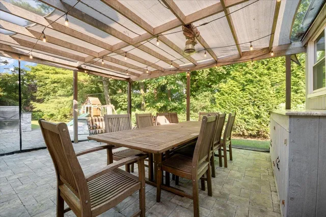 a view of a patio with a table and chairs and couches