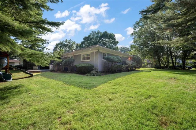 a front view of house with yard and green space