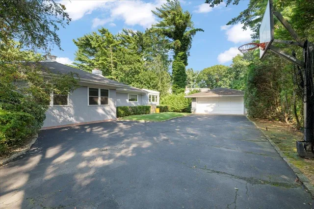 a view of a house with a yard and garage