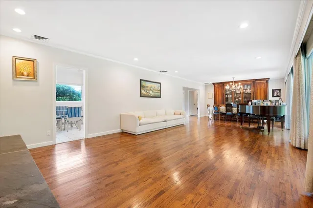 a view of a livingroom with furniture wooden floor and windows
