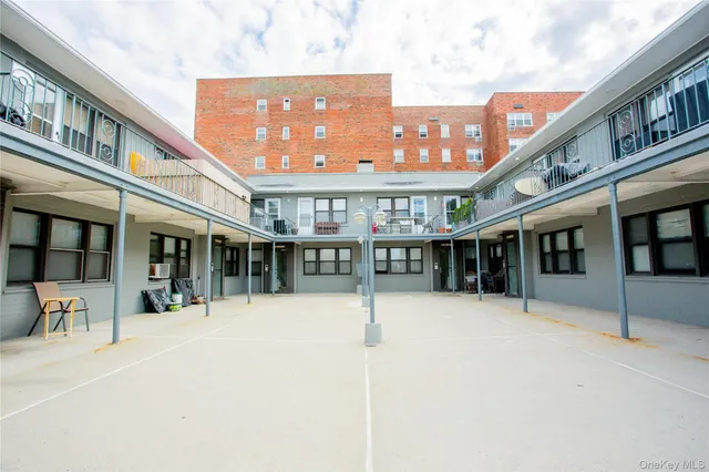 a front view of a building with a garden