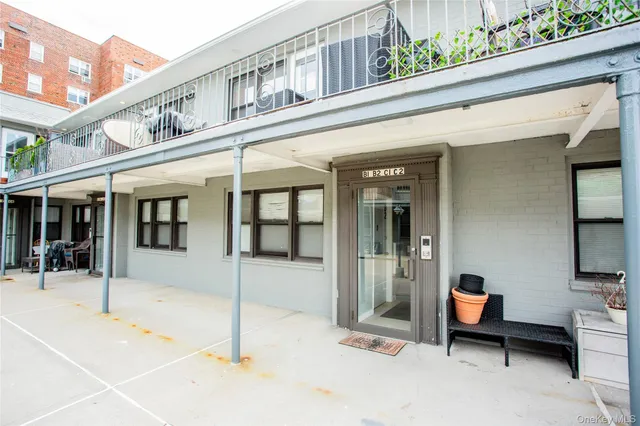 a balcony with furniture and a potted plant