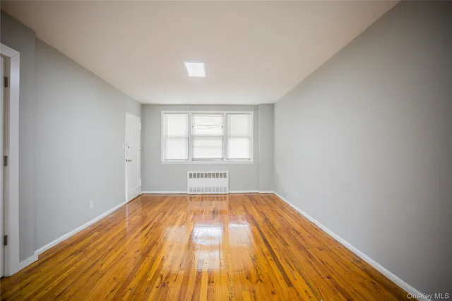 a view of a room with wooden floor and white walls