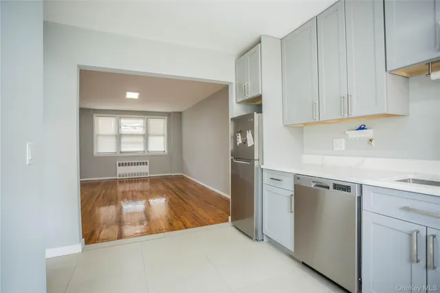a kitchen with white cabinets and a wooden floors
