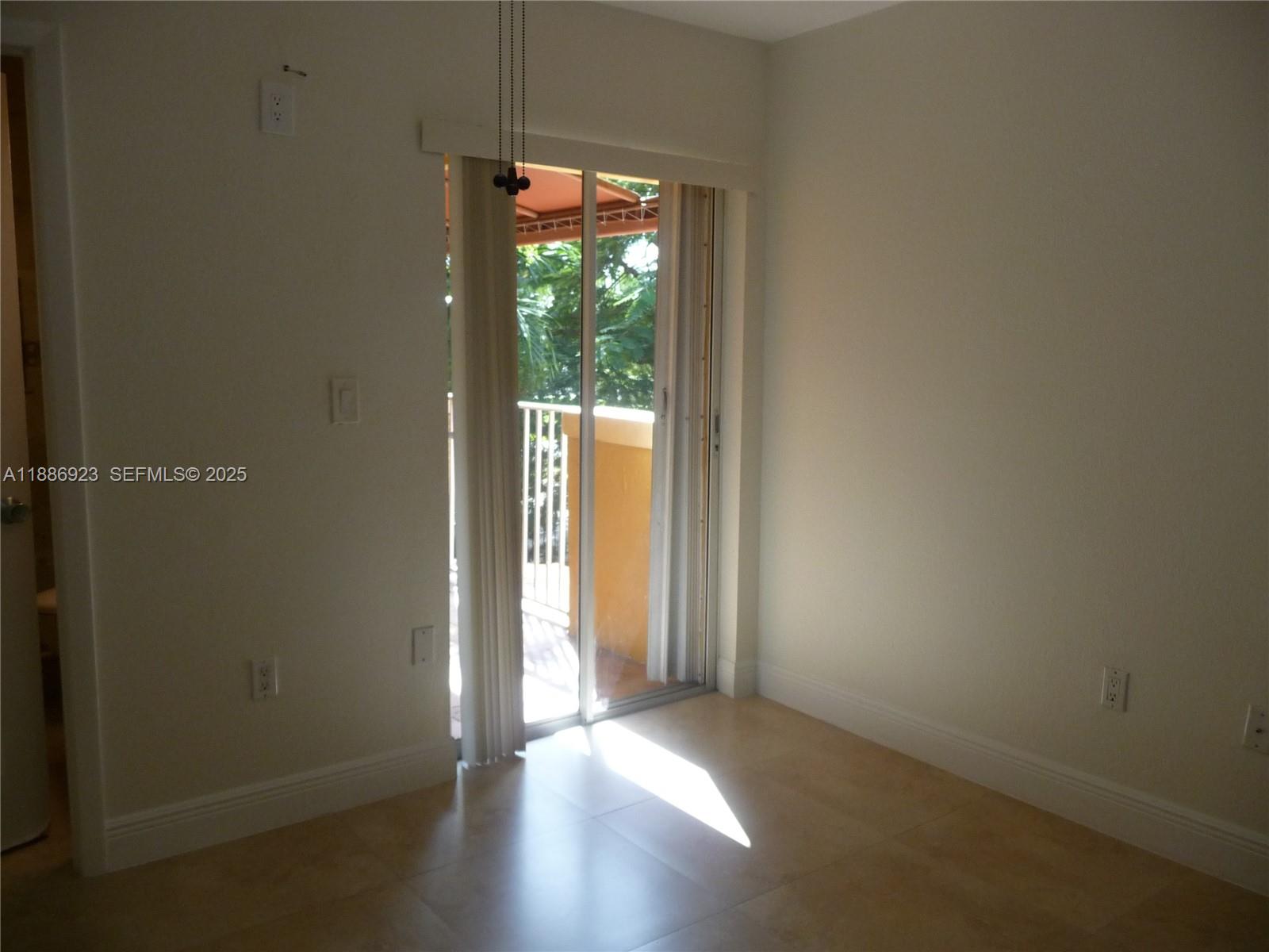 13904 Southwest 65th Terrace, Unit 8 Miami, FL 33183 - Photo 14 of 24 an empty room with wooden floor and windows