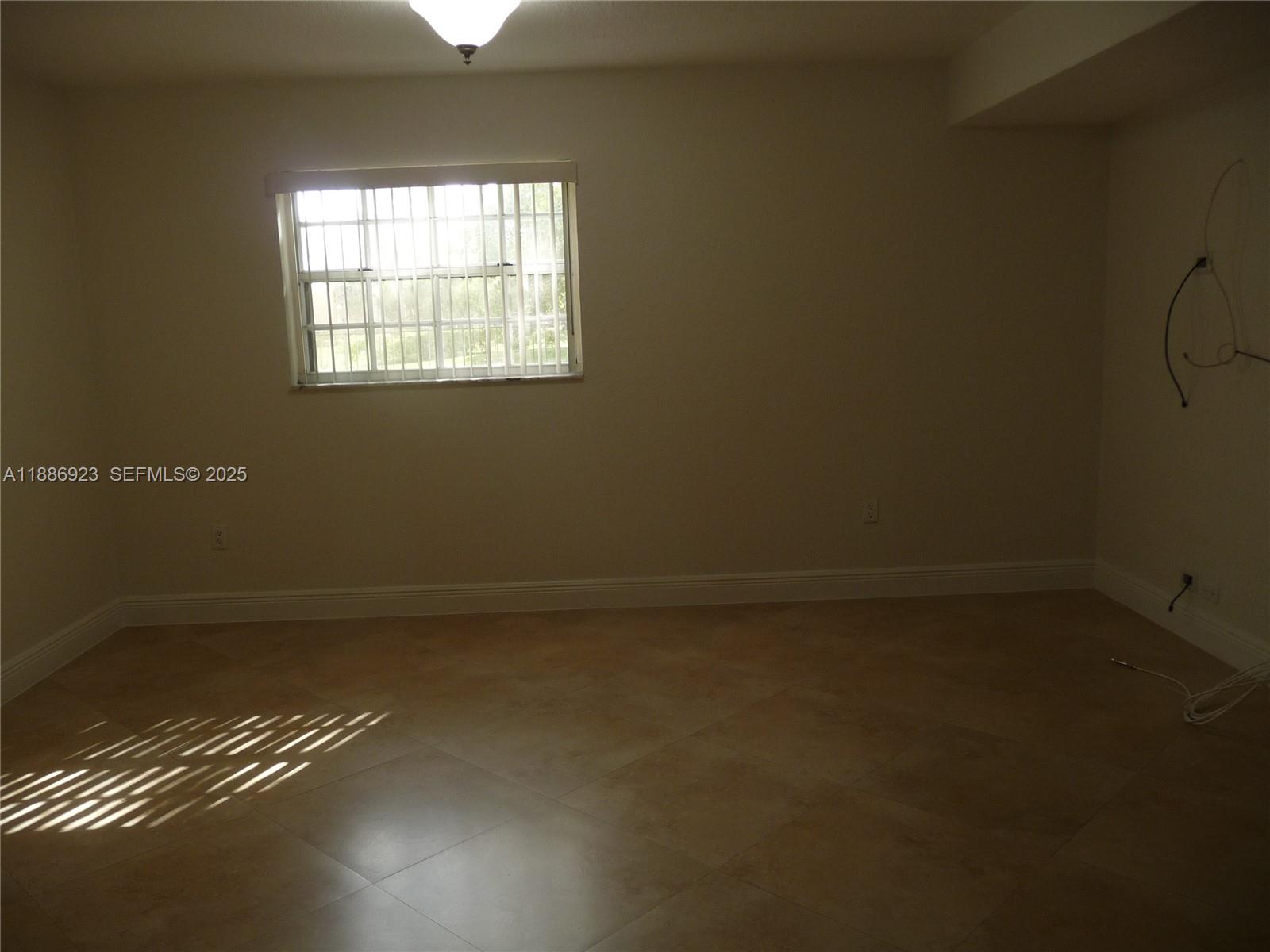 13904 Southwest 65th Terrace, Unit 8 Miami, FL 33183 - Photo 5 of 24 an empty room with a window