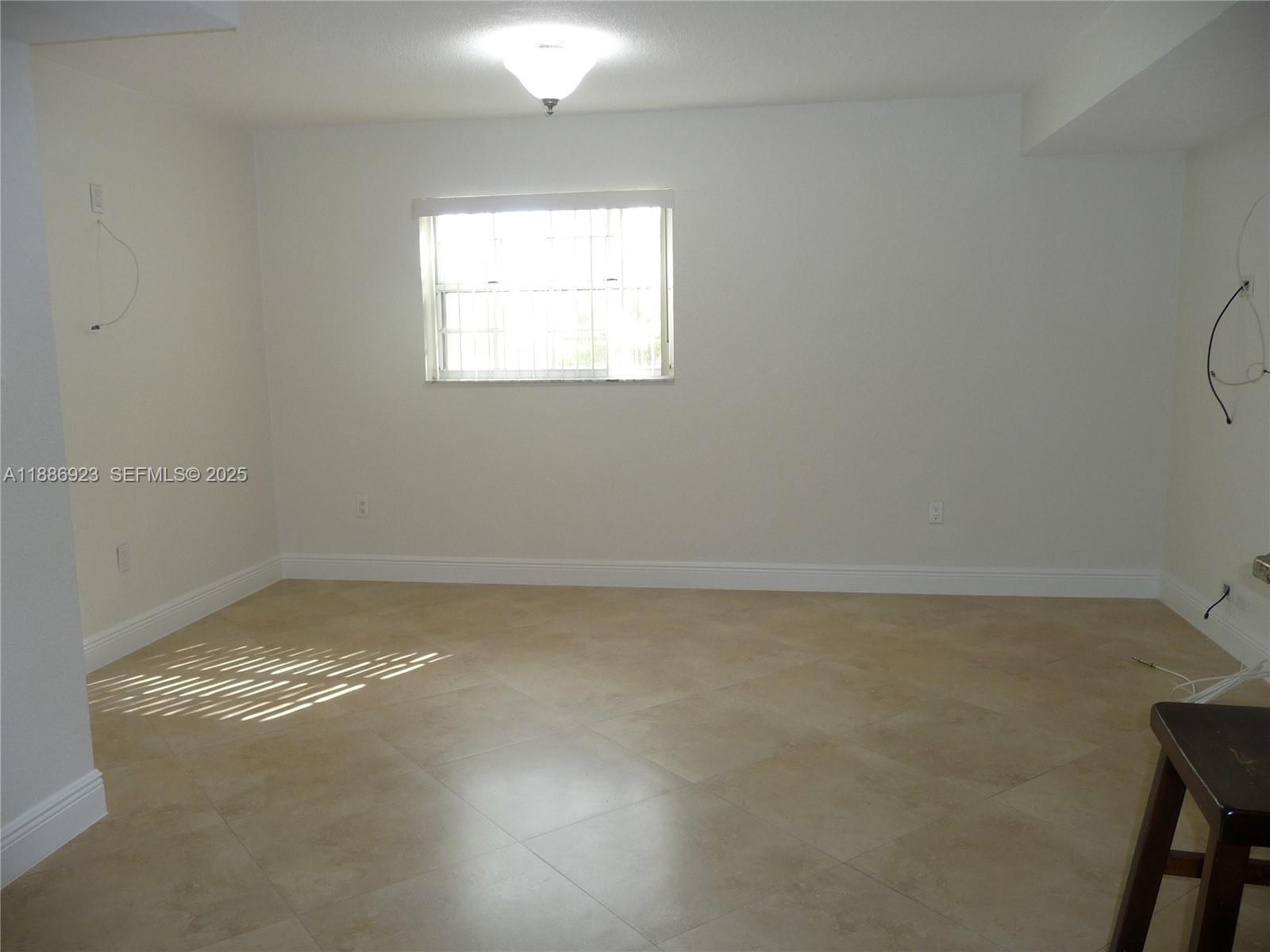 13904 Southwest 65th Terrace, Unit 8 Miami, FL 33183 - Photo 6 of 24 a view of a room that has a window in it