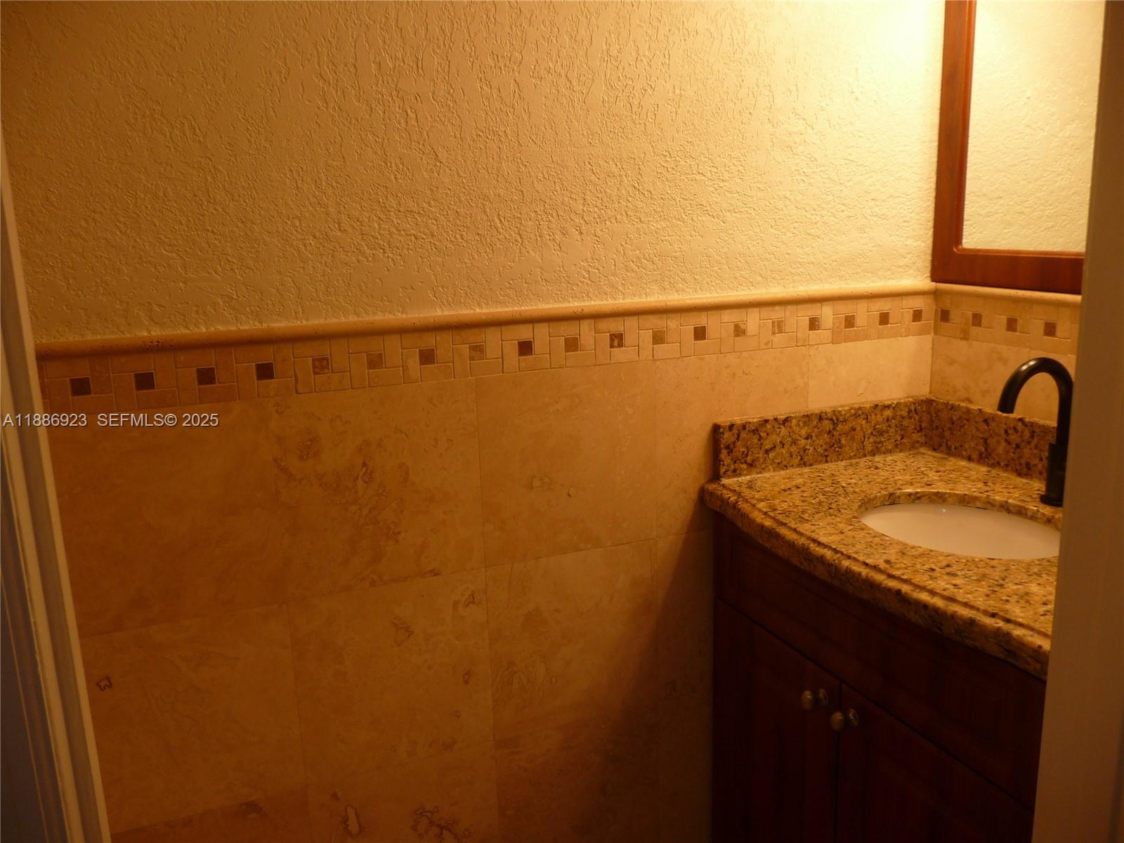 13904 Southwest 65th Terrace, Unit 8 Miami, FL 33183 - Photo 8 of 24 a bathroom with a sink and mirror