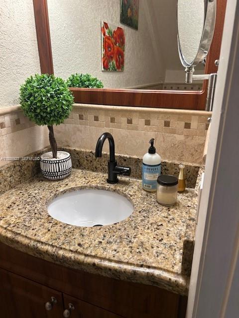 13904 Southwest 65th Terrace, Unit 8 Miami, FL 33183 - Photo 9 of 24 a bathroom with a granite countertop sink and a mirror