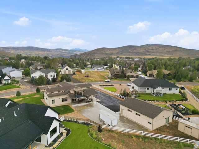 560 Aspen Road Francis, UT 84036 - Photo 8 of 59 Expansive property featuring a large residence, separate detached building, paved driveways, and manicured landscaping with white fencing