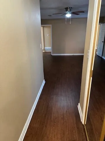 wooden floor in an empty room next to a window