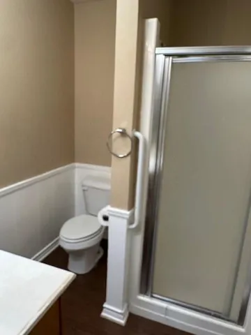 a white toilet sitting next to a bathroom sink
