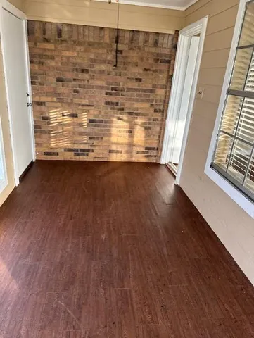 a view of water heater room with wooden floor