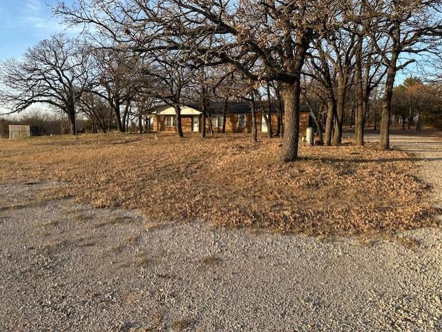 1516 Blackjack Road West Aubrey, TX 76227 - Photo 22 of 27 a view of house with trees in the background