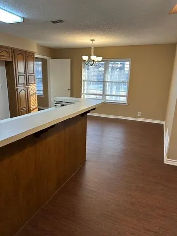 a view of a kitchen with granite countertop cabinets and a wooden floor