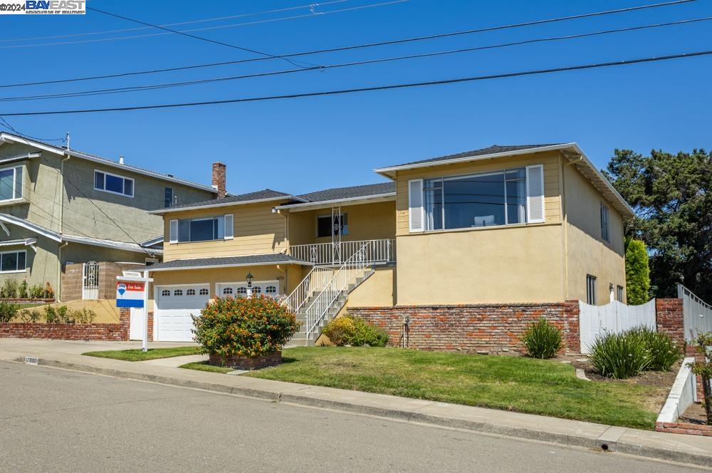 a front view of a house with a garden and garage