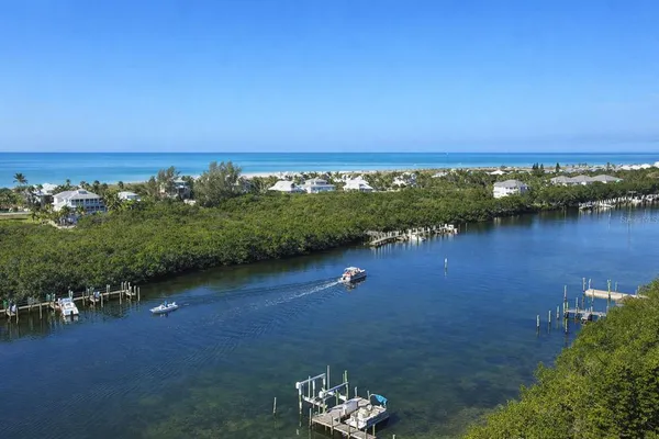 an aerial view of a houses with a yard and lake view