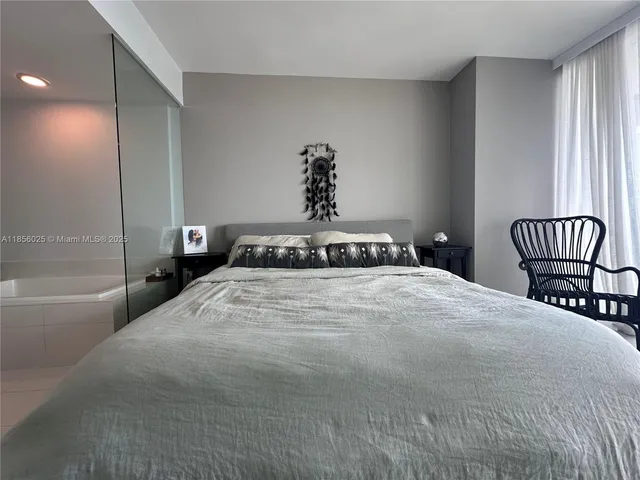 a bedroom with a bed and a chair