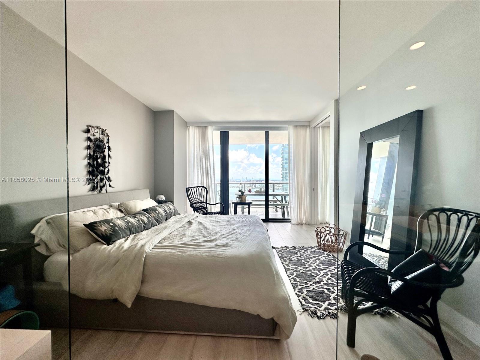 650 Northeast 32nd Street, Unit 4003 Miami, FL 33137 - Photo 15 of 32 a bedroom with furniture and a large window