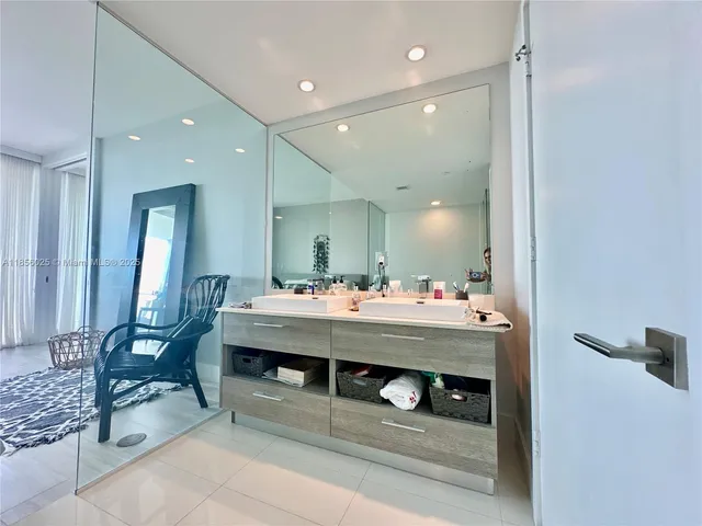a bathroom with a sink a mirror and a shower