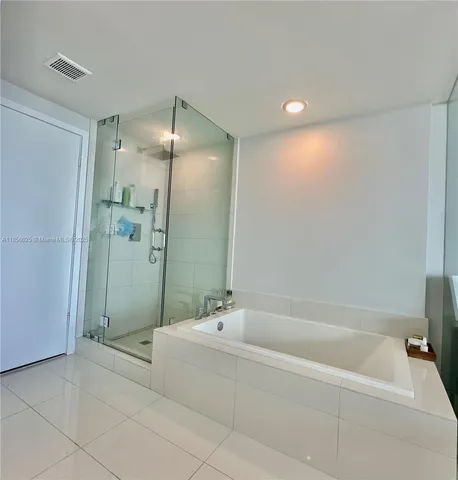 a spacious bathroom with a bathtub and shower