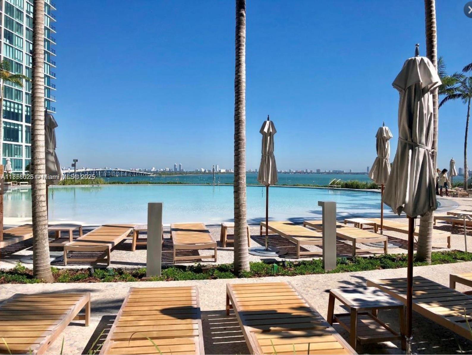 650 Northeast 32nd Street, Unit 4003 Miami, FL 33137 - Photo 21 of 32 a view of a lake with a table and chairs