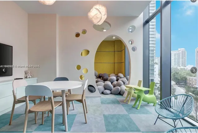 a bedroom with a table and chairs