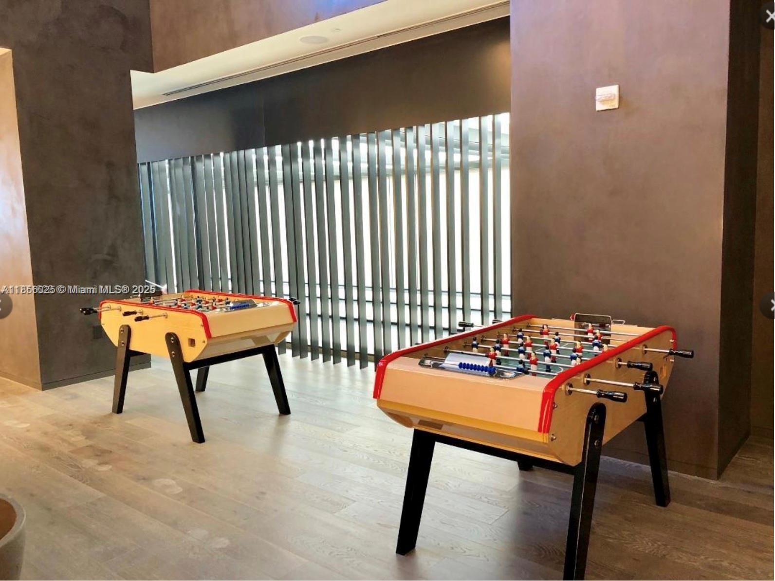 650 Northeast 32nd Street, Unit 4003 Miami, FL 33137 - Photo 26 of 32 a bedroom with a table and chairs