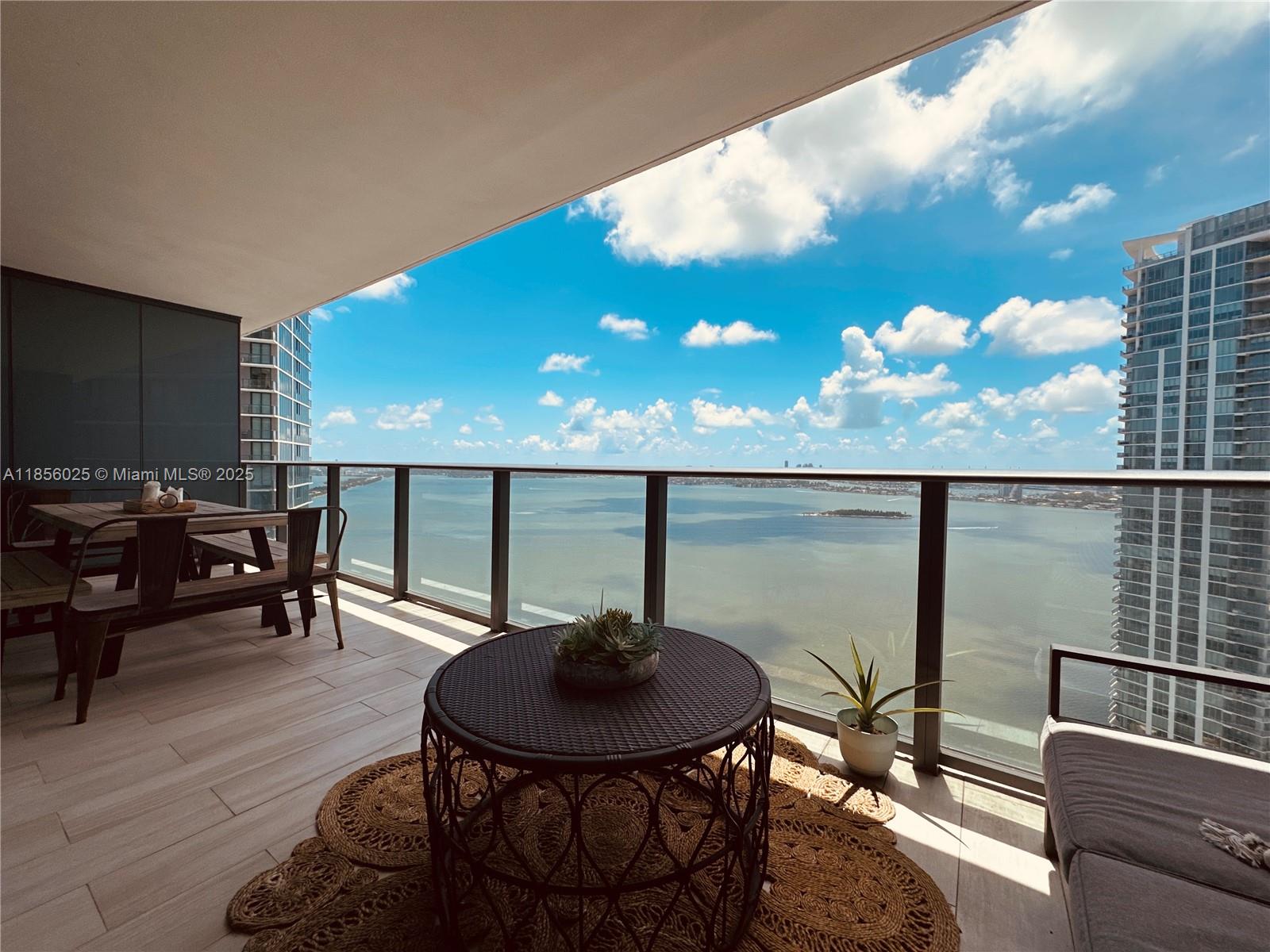 650 Northeast 32nd Street, Unit 4003 Miami, FL 33137 - Photo 3 of 32 a view of a chairs and table in patio