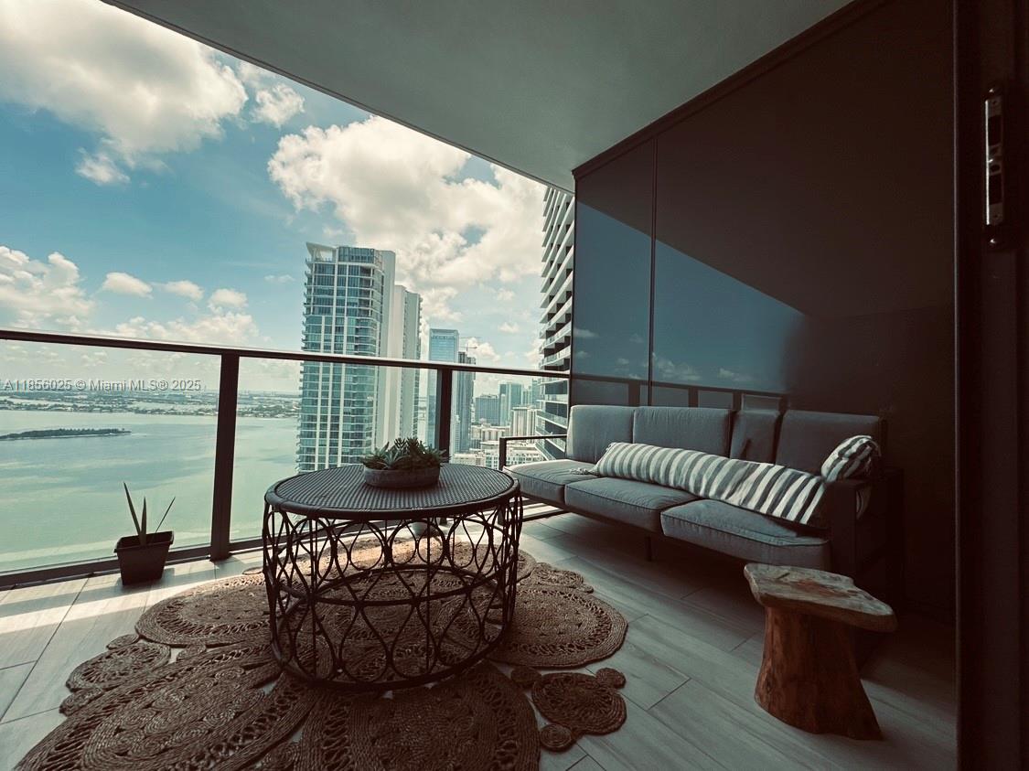 650 Northeast 32nd Street, Unit 4003 Miami, FL 33137 - Photo 4 of 32 a living room with furniture and a large window