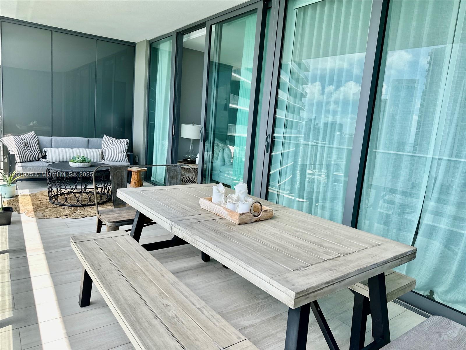 650 Northeast 32nd Street, Unit 4003 Miami, FL 33137 - Photo 7 of 32 a dining table sitting next to a large window