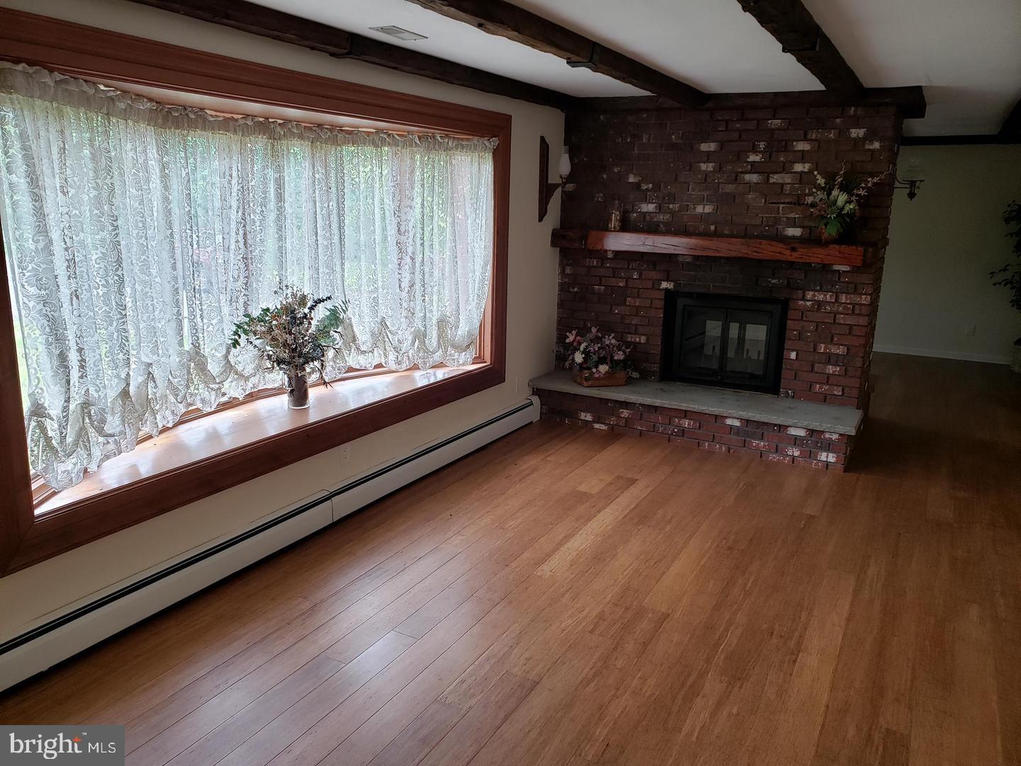 102 Gilbert Road Bordentown, NJ 08505 - Photo 10 of 28 a view of an empty room with wooden floor and a window