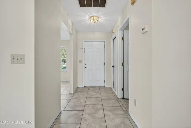 a view of an empty room with glass door