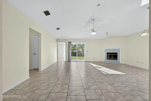 a view of an empty room with glass door