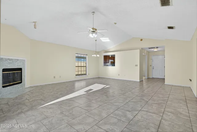 a view of an empty room with a fireplace
