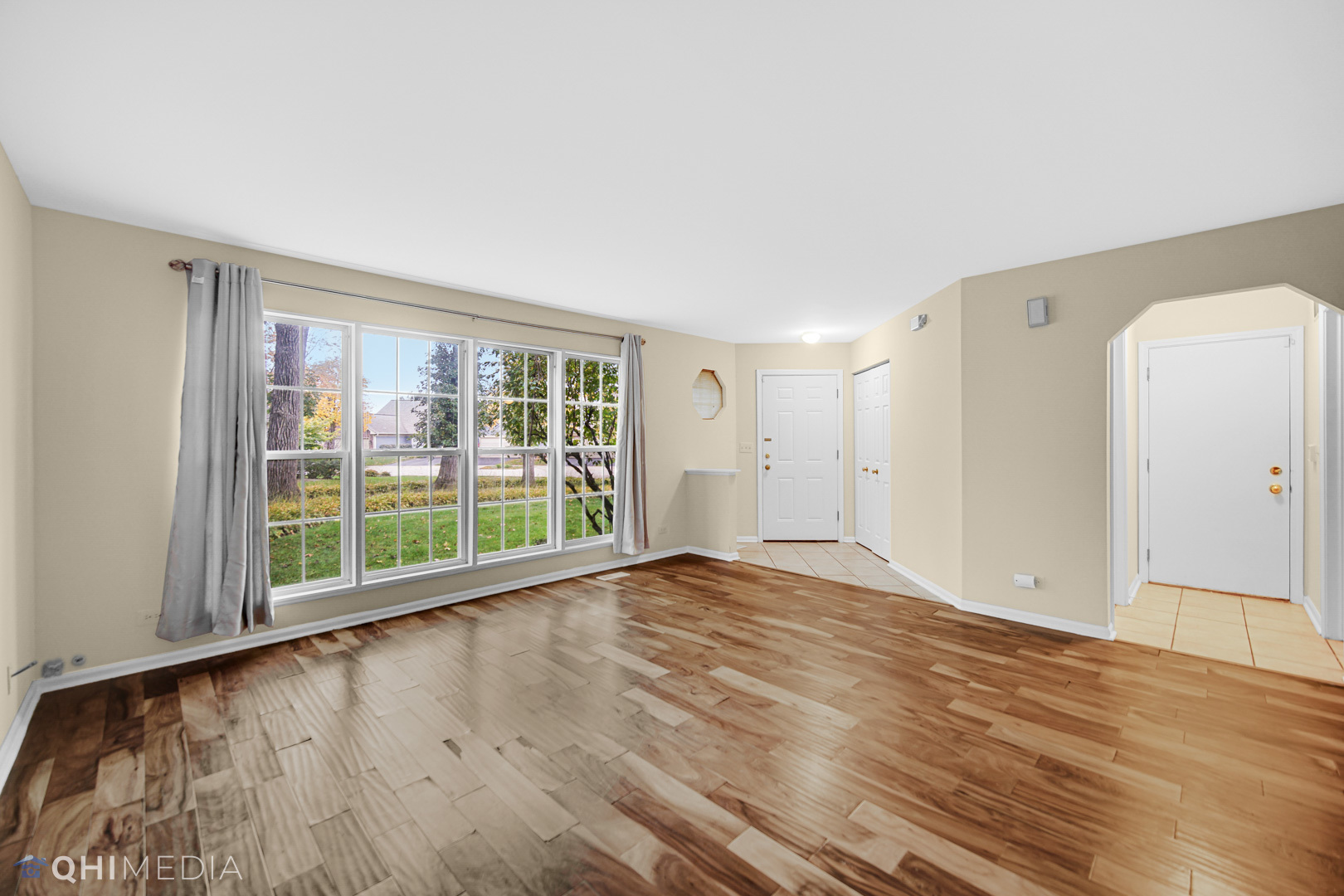 1123 Coldspring Road, Unit 1123 Elgin, IL 60120 - Photo 5 of 23 a view of an empty room with wooden floor and a window