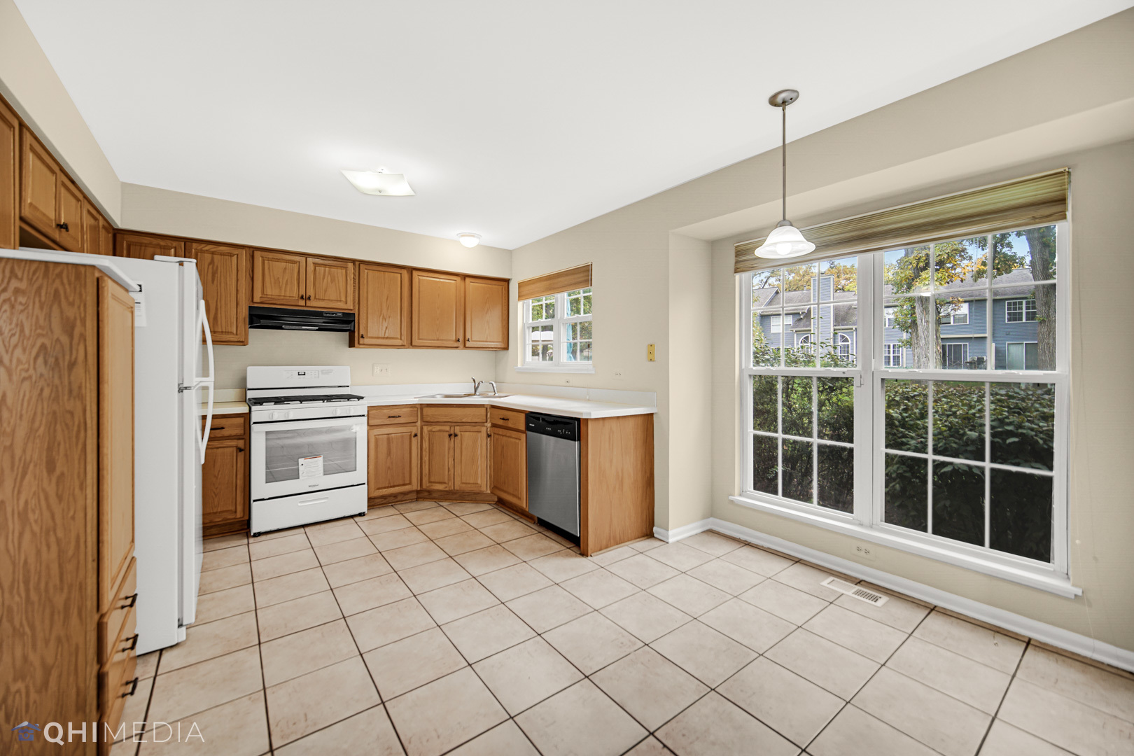 1123 Coldspring Road, Unit 1123 Elgin, IL 60120 - Photo 8 of 23 a kitchen with a stove a sink dishwasher a refrigerator and cabinets