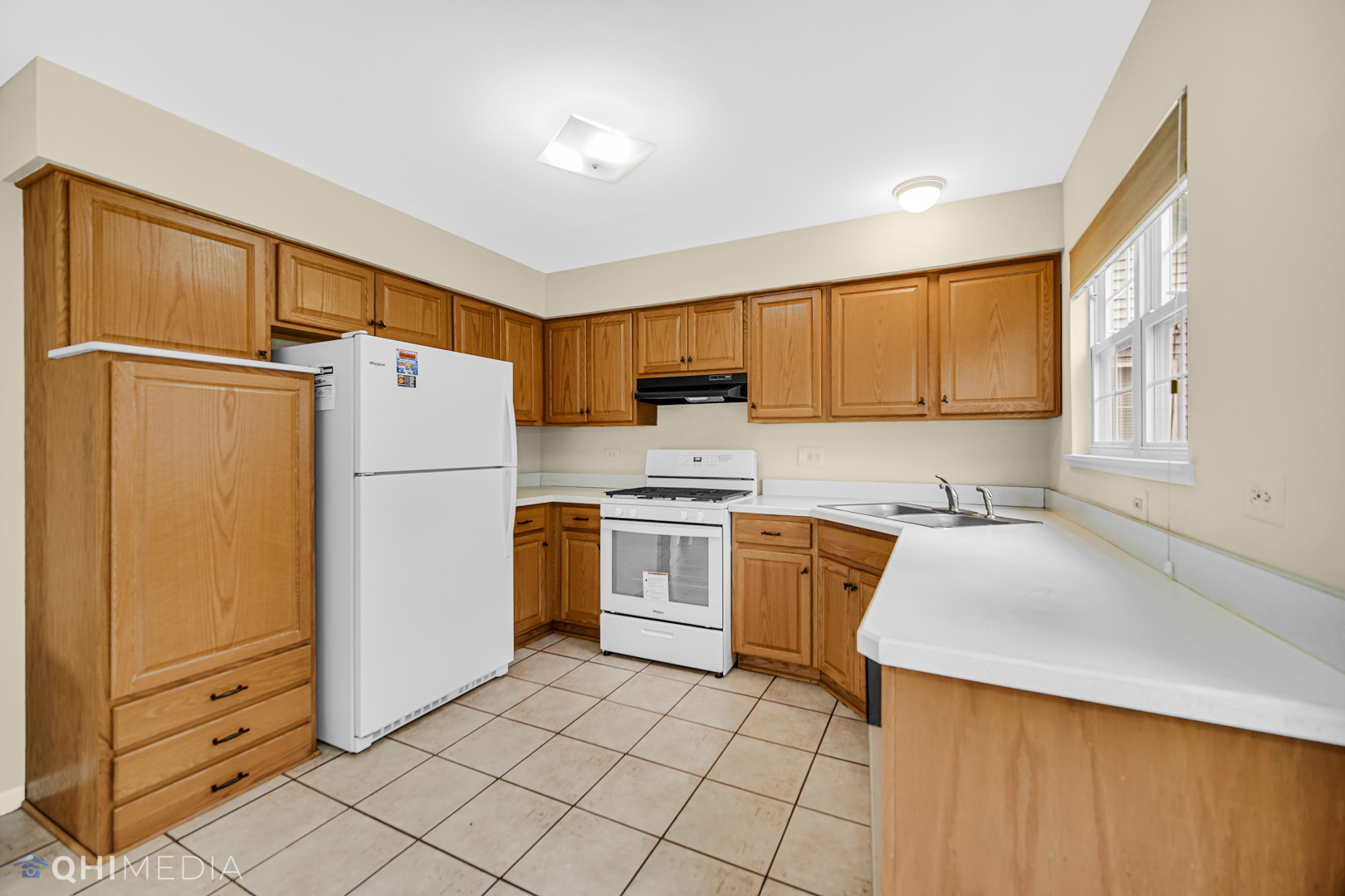 1123 Coldspring Road, Unit 1123 Elgin, IL 60120 - Photo 9 of 23 a kitchen with a refrigerator sink stove and cabinets