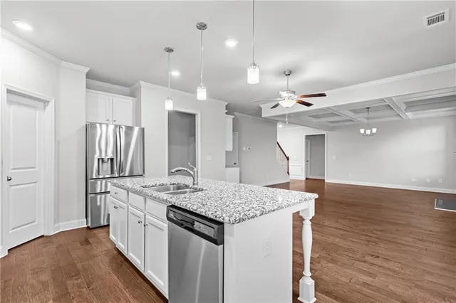 a kitchen with a sink a refrigerator and a window