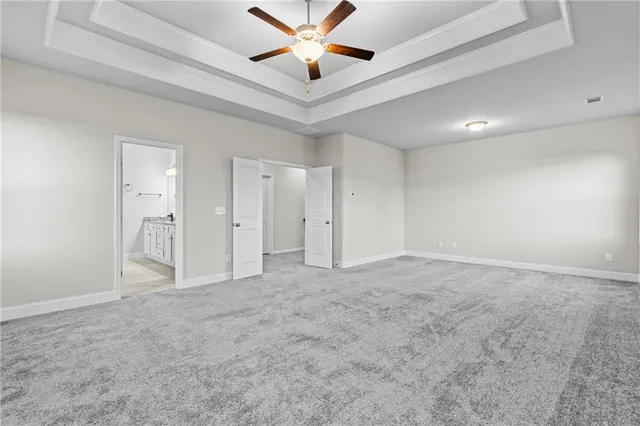 an empty room with fan and a ceiling fan