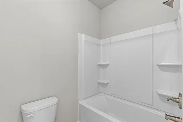 a bathroom with a toilet and a bathtub