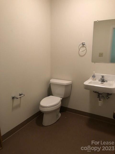 360 1st Avenue Southwest, Unit B Hickory, NC 28602 - Photo 9 of 9 a bathroom with a toilet a sink and mirror