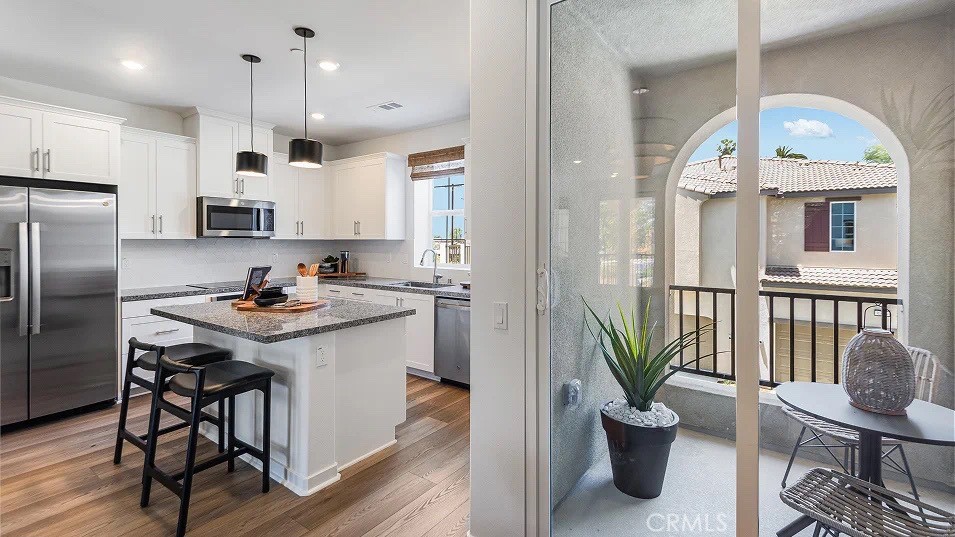 8421 Tapia Way Rancho Cucamonga, CA 91730 - Photo 2 of 24 a kitchen with a sink stainless steel appliances and white cabinets