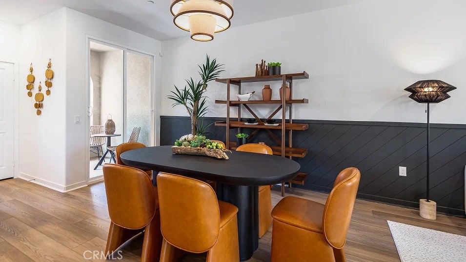 8421 Tapia Way Rancho Cucamonga, CA 91730 - Photo 7 of 24 a view of a dining room with furniture and wooden floor
