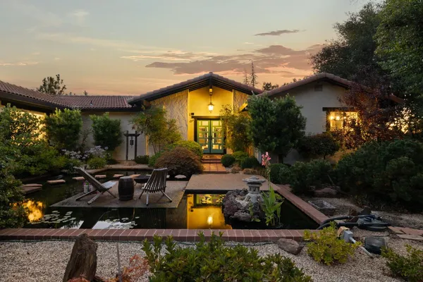 an aerial view of a house with swimming pool garden and patio