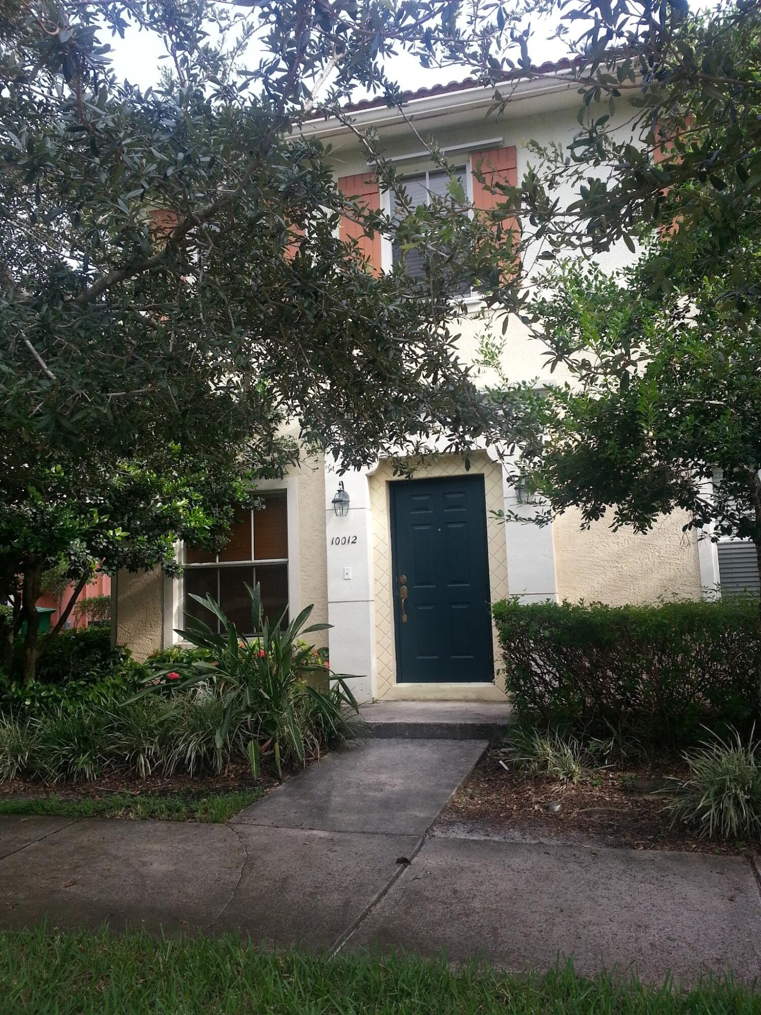 10012 Southwest 23rd Street Miramar, FL 33025 - Photo 1 of 6 a front view of a house with plants