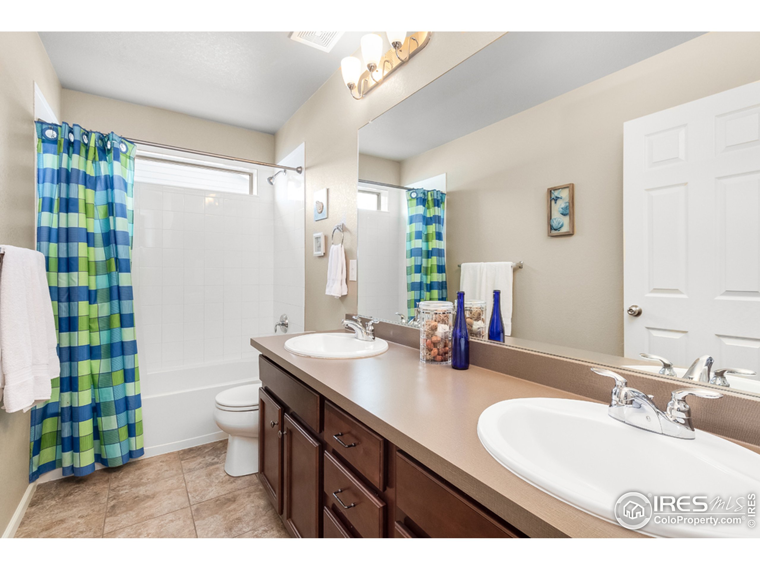6559 Tombstone Ridge Road Timnath, CO 80547 - Photo 19 of 30 a bathroom with a double vanity sink toilet and a mirror